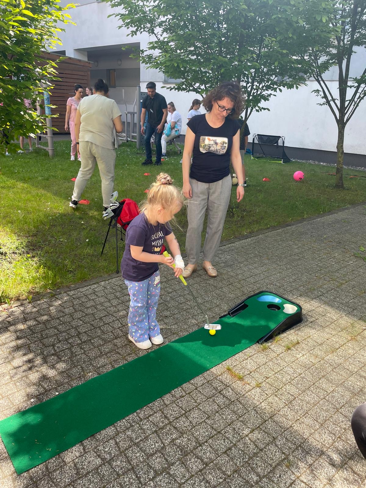 dziewczynka grająca w golfa na patio szpitalnym